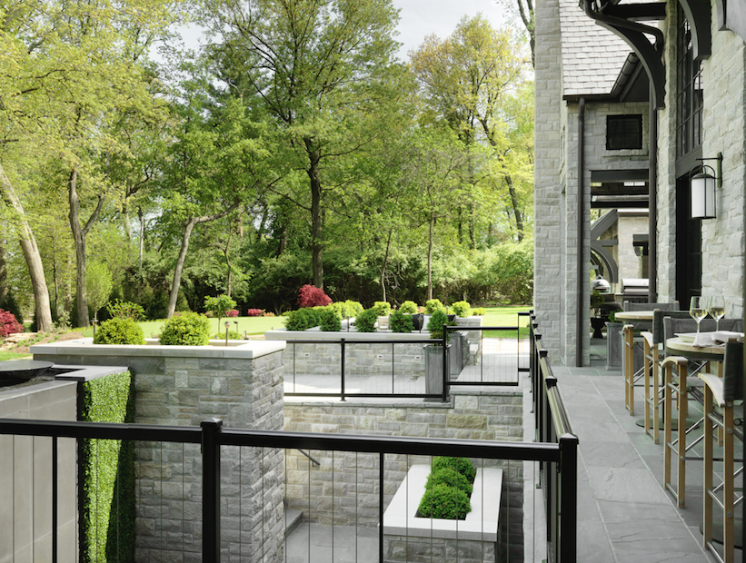 An expansive deck outside the main living area overlooks a waterfall and gorgeous landscaping.