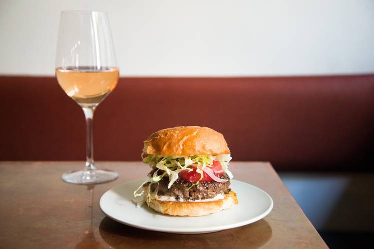 At King Bee, the Hour of Good Cheer special pairs a signature burger and a glass of bubbly rosé for $20. PHOTO: KATIE BURTON
