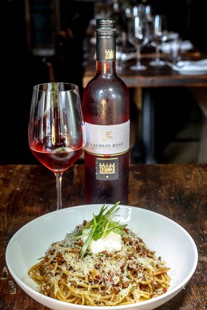 A rosé paired with the spaghettini with Cincinnatus' chili, cranberry beans and aged cheddar at In Vino. PHOTO:BRYAN THATCHER