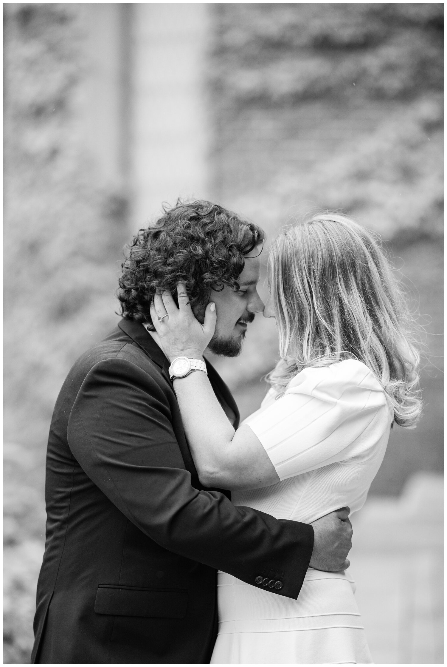 black and white portrait couple kissing outdoors