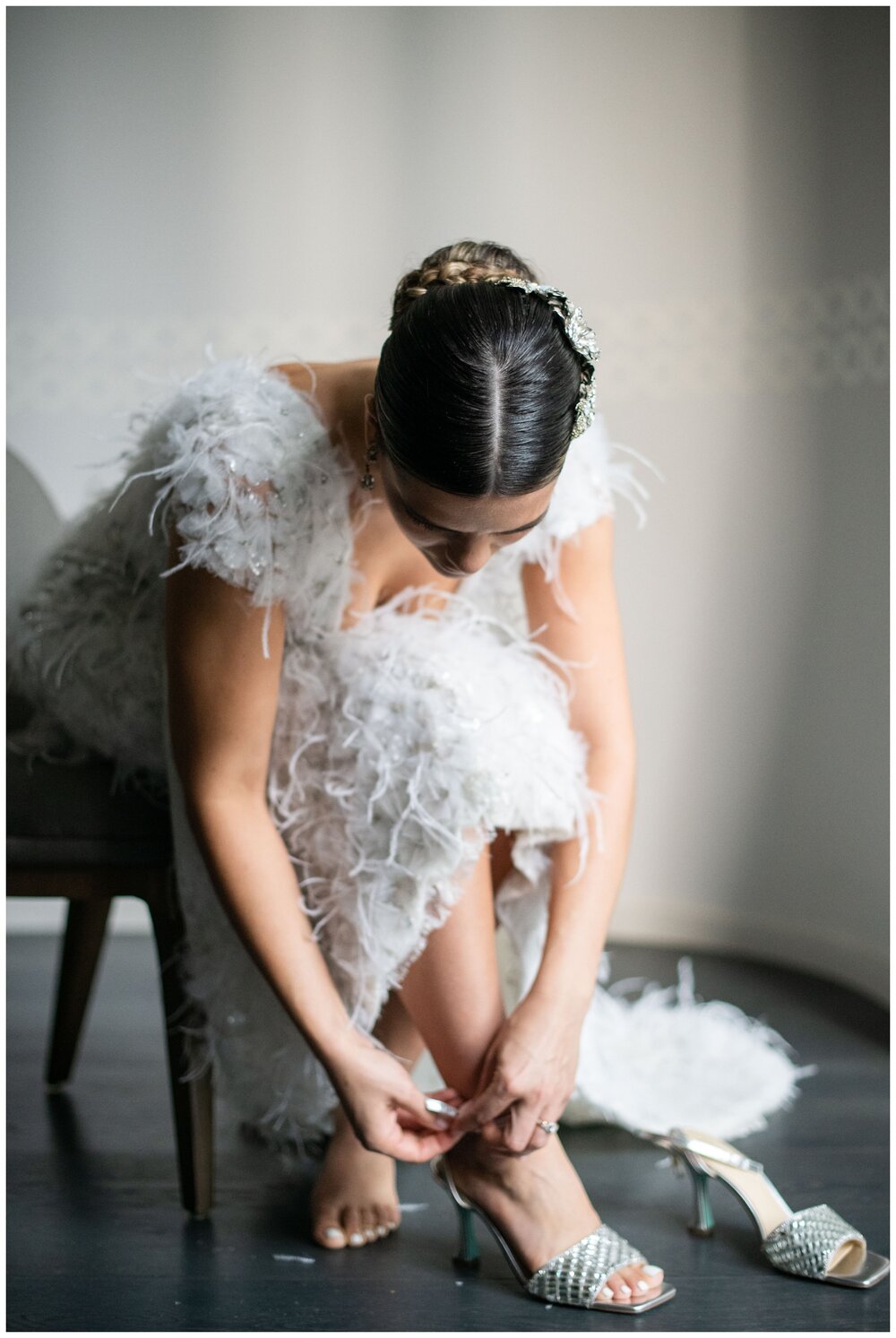 bride putting on wedding shoes inside Vizcaya Museum for Miami wedding photographer