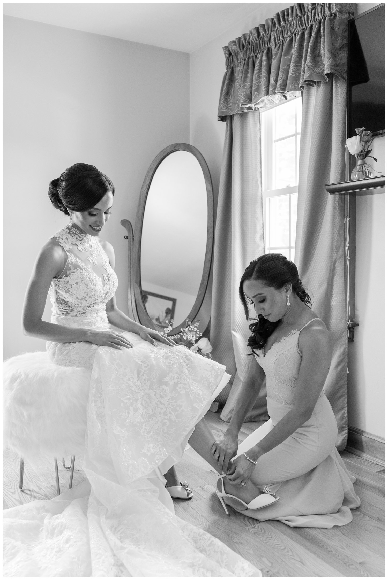 bride getting ready putting on wedding shoes