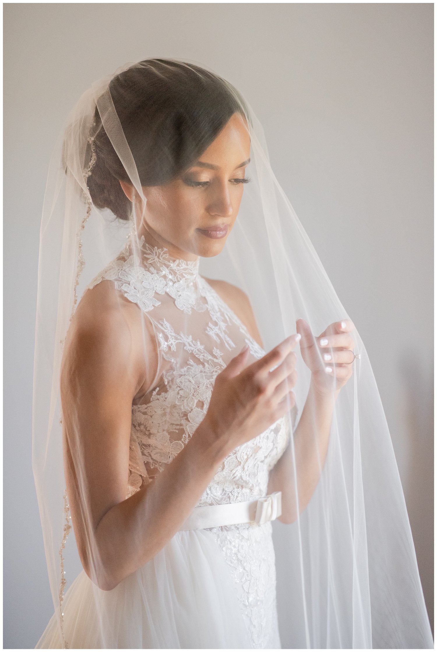 bridal portrait with brides hands under her veil