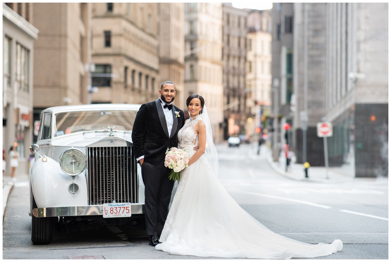 newlywed couple standing in front of Rolls Royce in Boston street