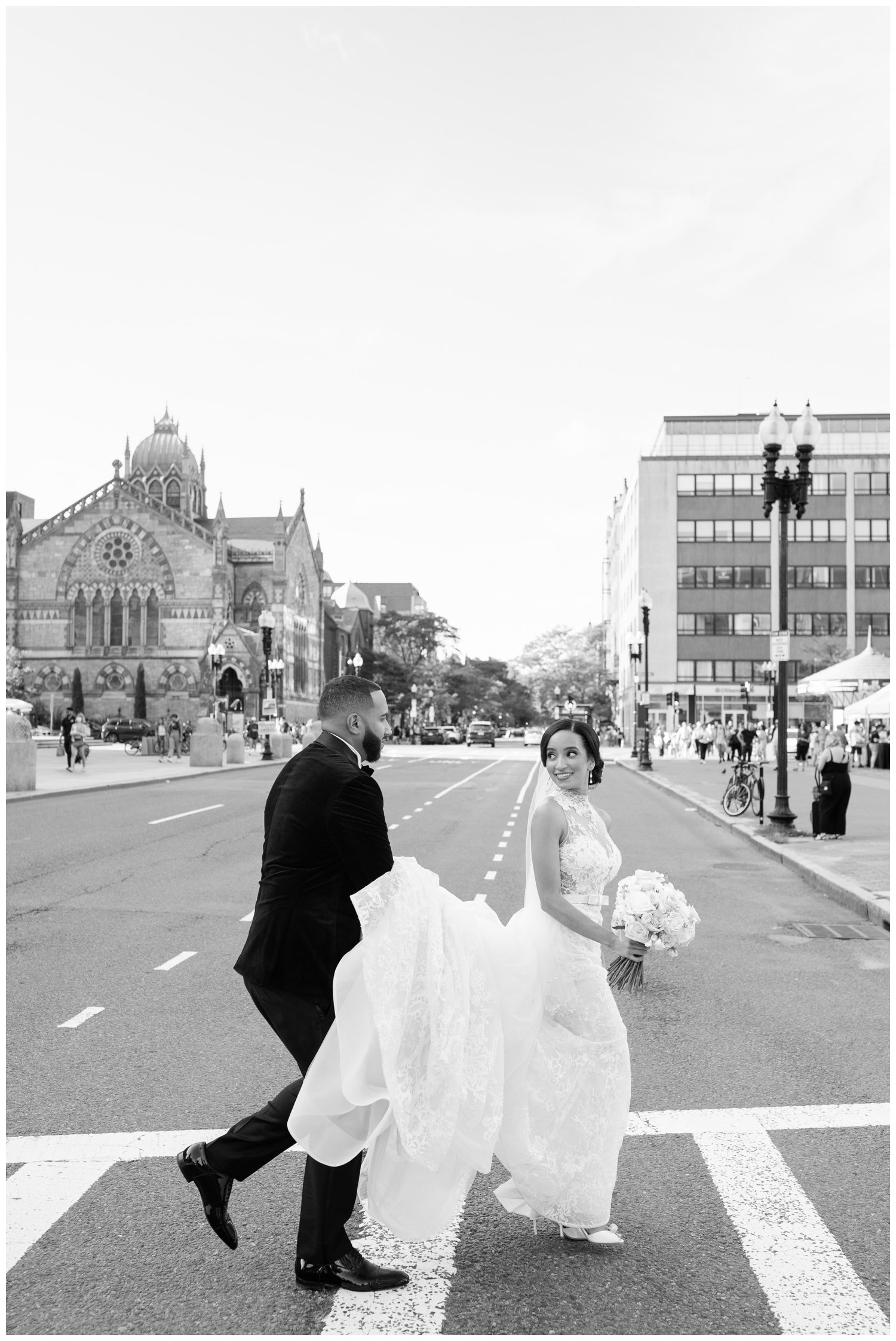 bride and groom holding hands and crossing a Boston street