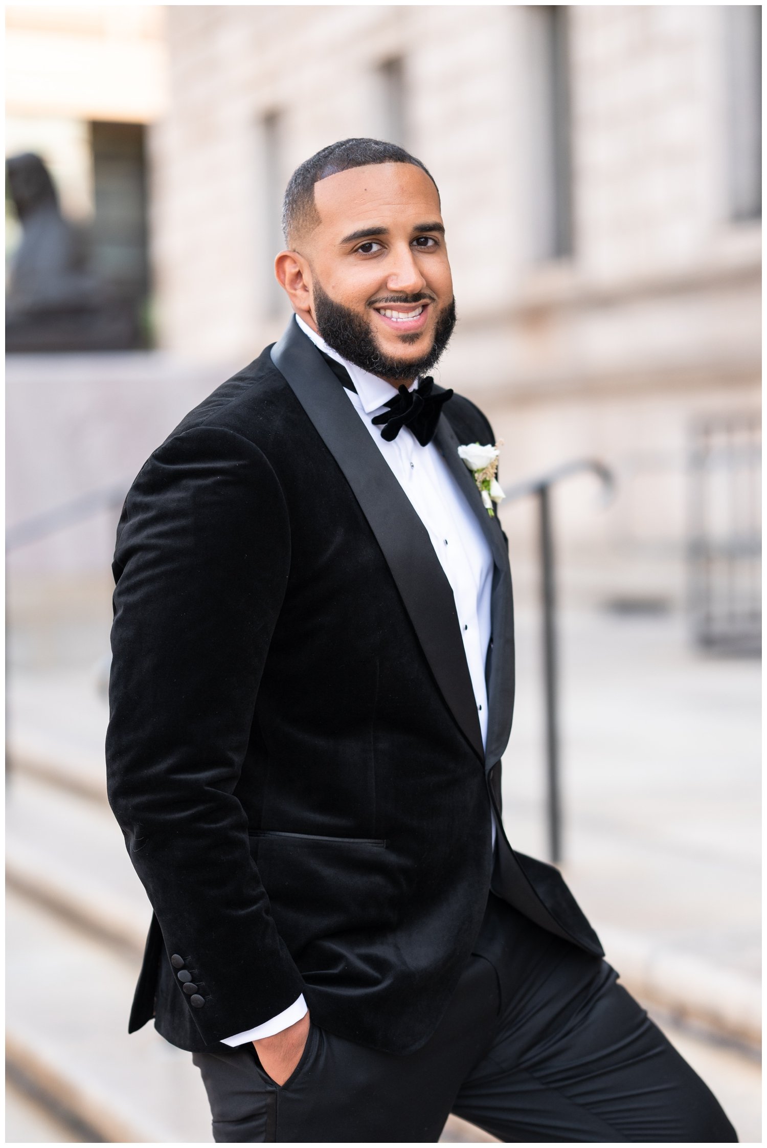 groom standing on steps of Boston Public Library for Fairmont Copley Plaza wedding
