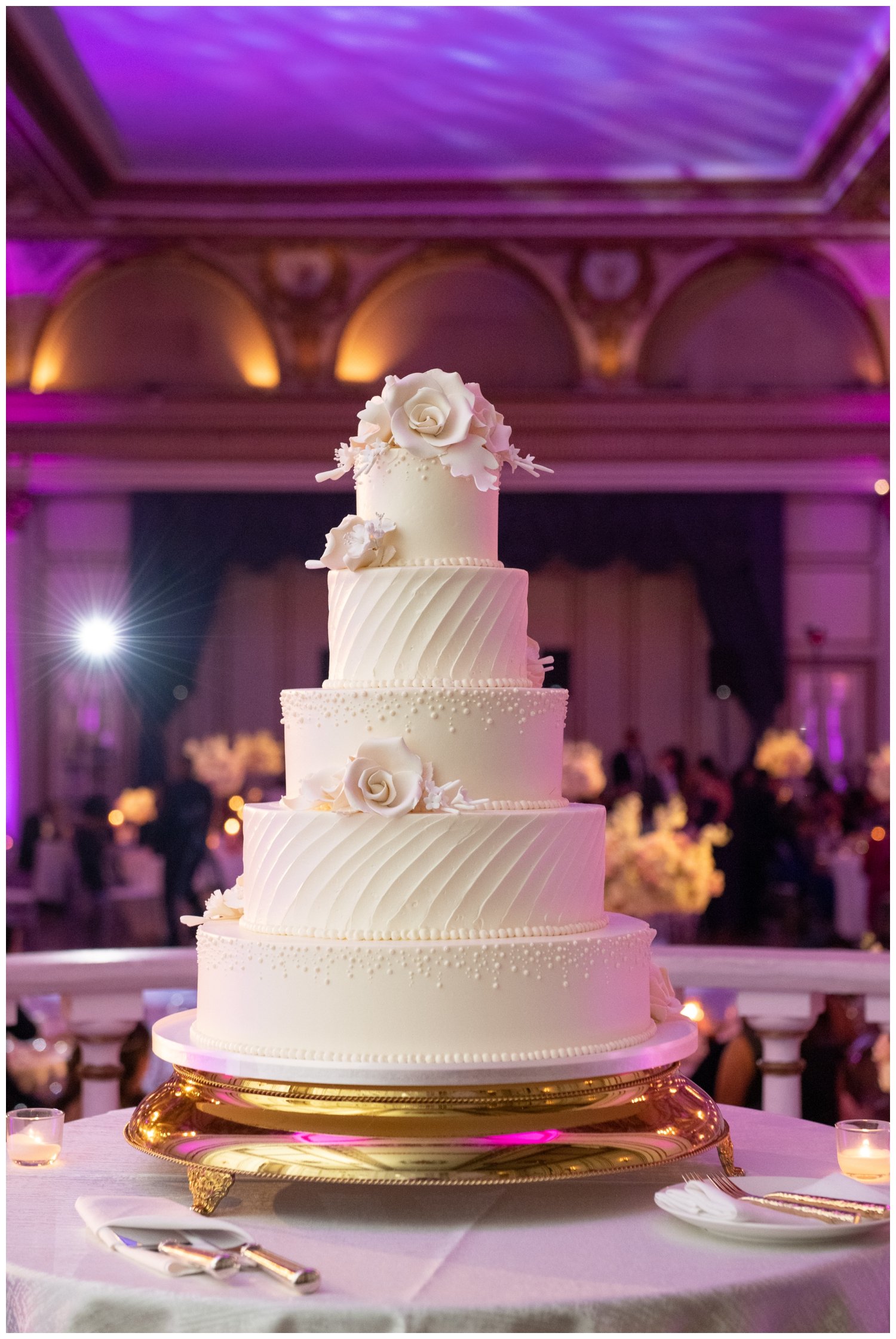 five tier all white wedding cake inside Fairmont Copley Plaza Hotel wedding