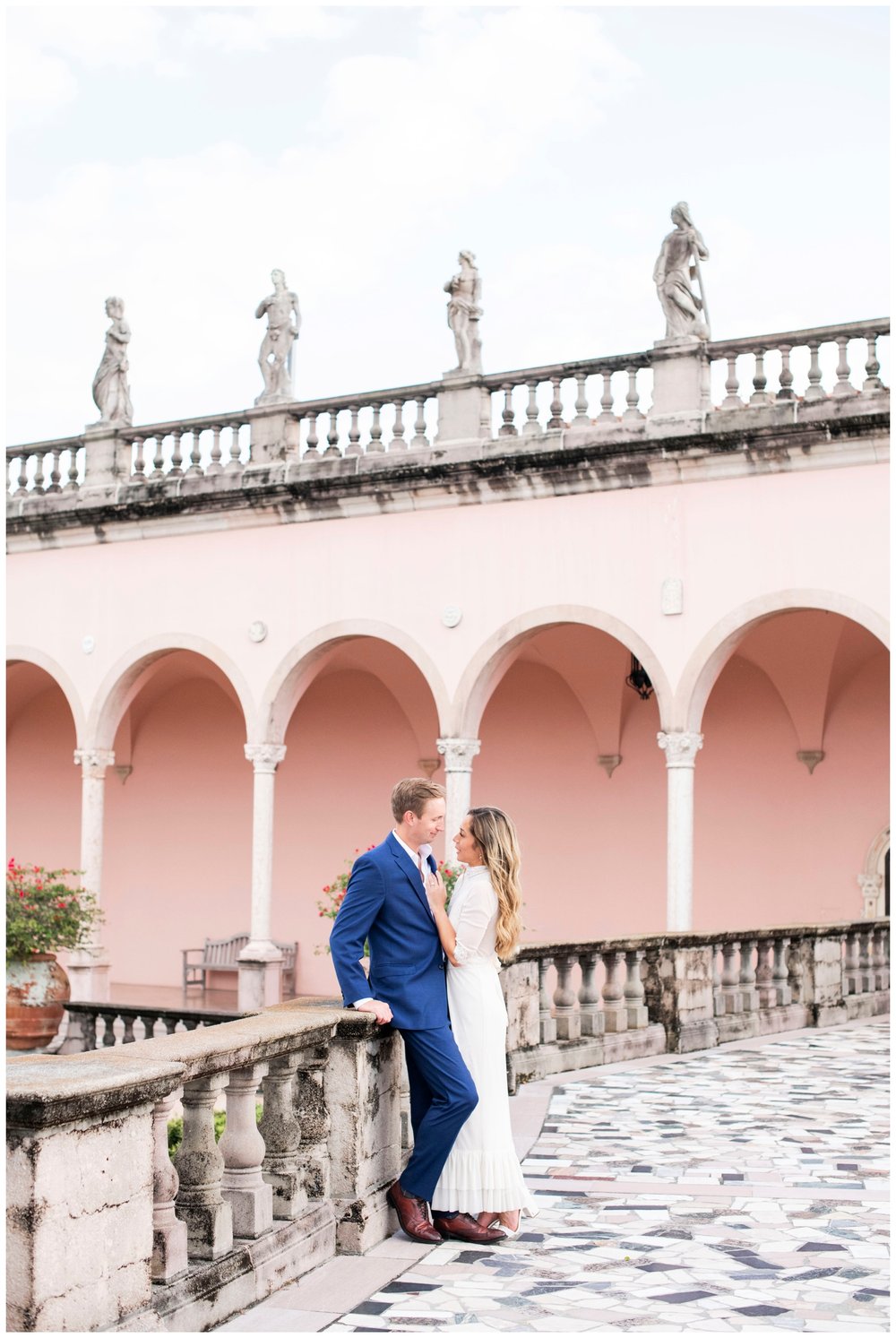 engaged couple in cream dress and blue suit posing outdoors for  Miami Wedding Photographer