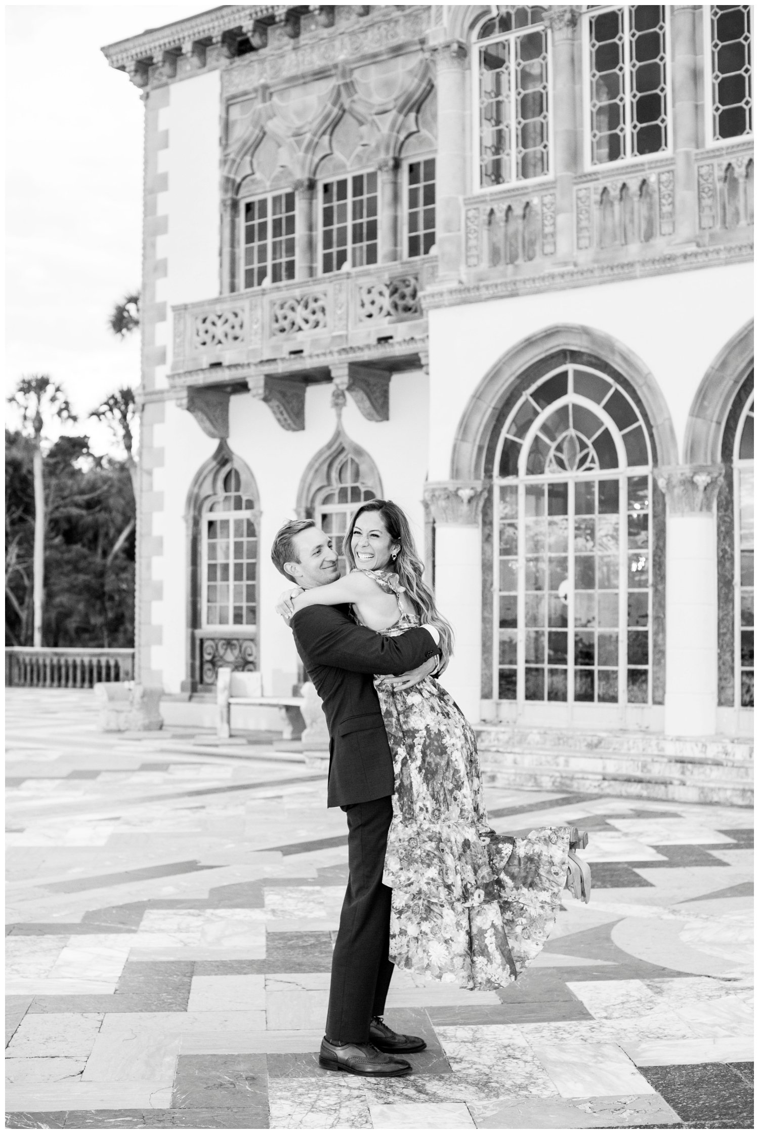 black and white image of groom lifting bride for Miami wedding photographer