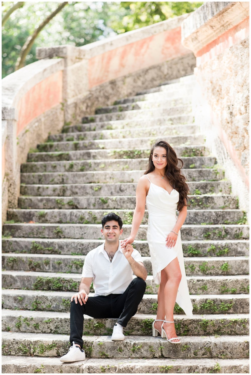 engaged couple posing on the Vizcaya Museum and Garden stairs outside