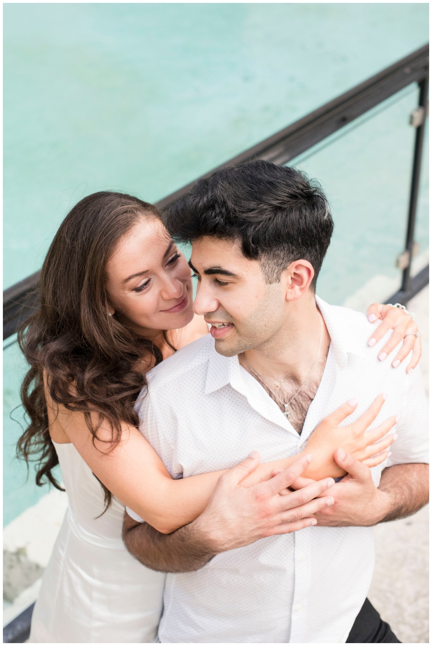 engaged couple hugging by a waterfront in Miami, Florida