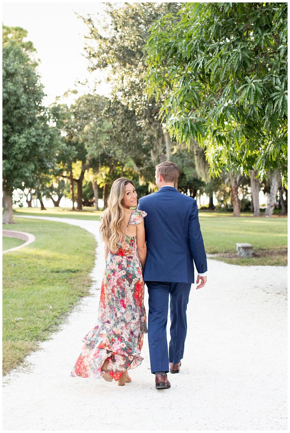 engaged couple holding hands and walking in Florida 