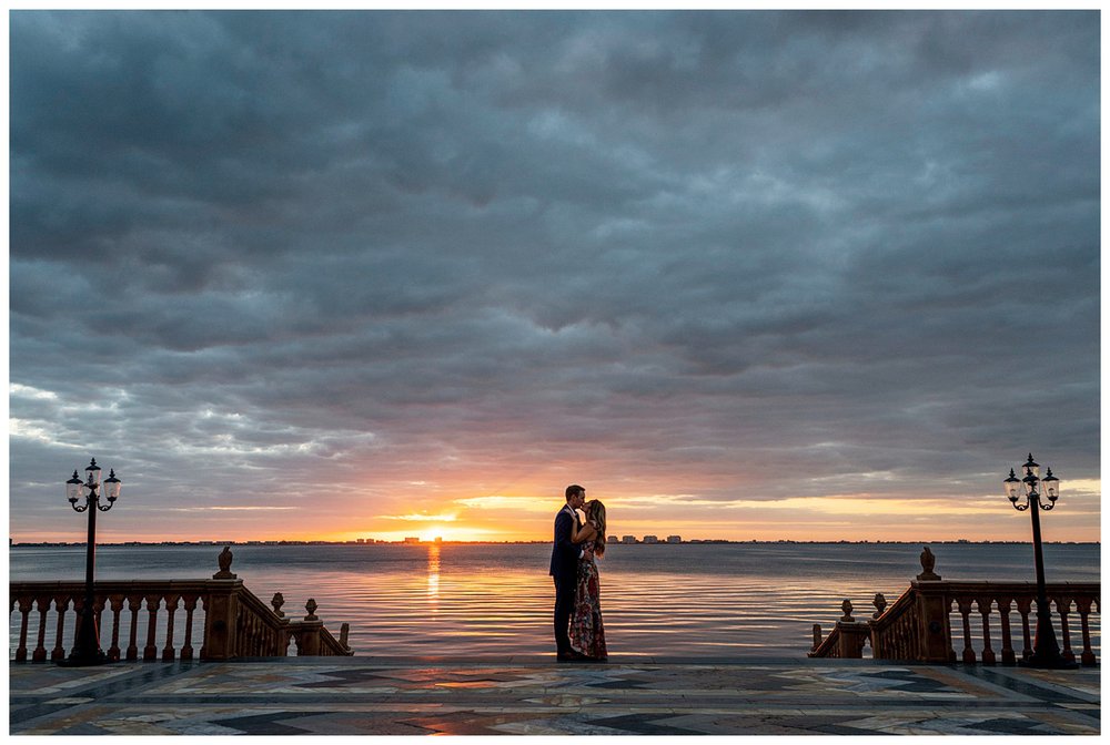 engaged couple standing in front of the ocean during sunset for Miami wedding photographer