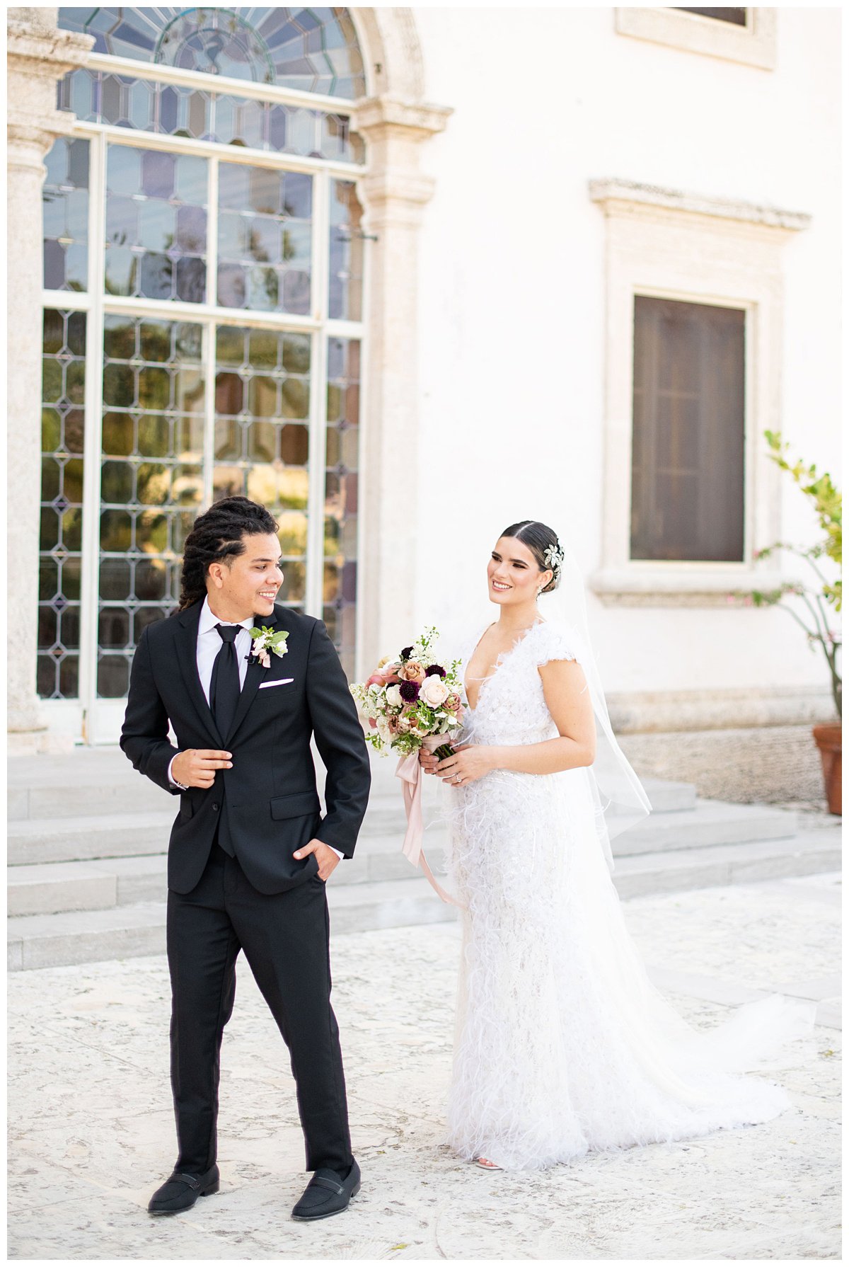 first look with Miami wedding photographer outside the windows at Vizcaya Museum and Gardens