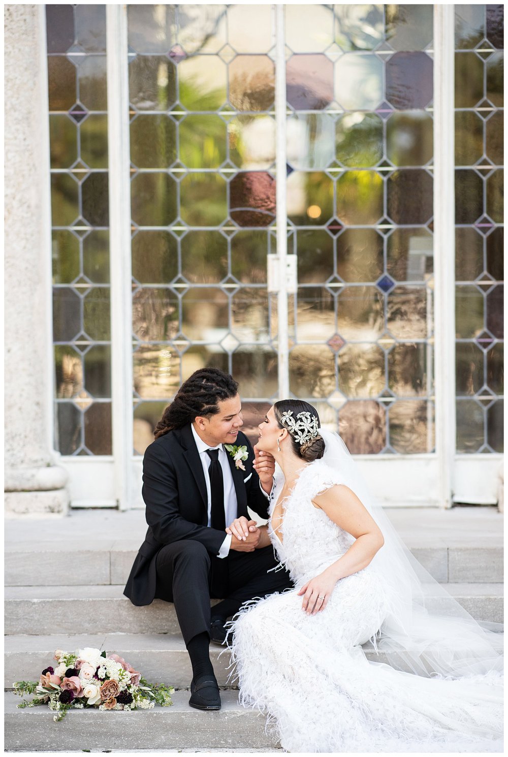 bride and groom sitting on steps at Vizcaya Museum and Gardens for Miami wedding photographer