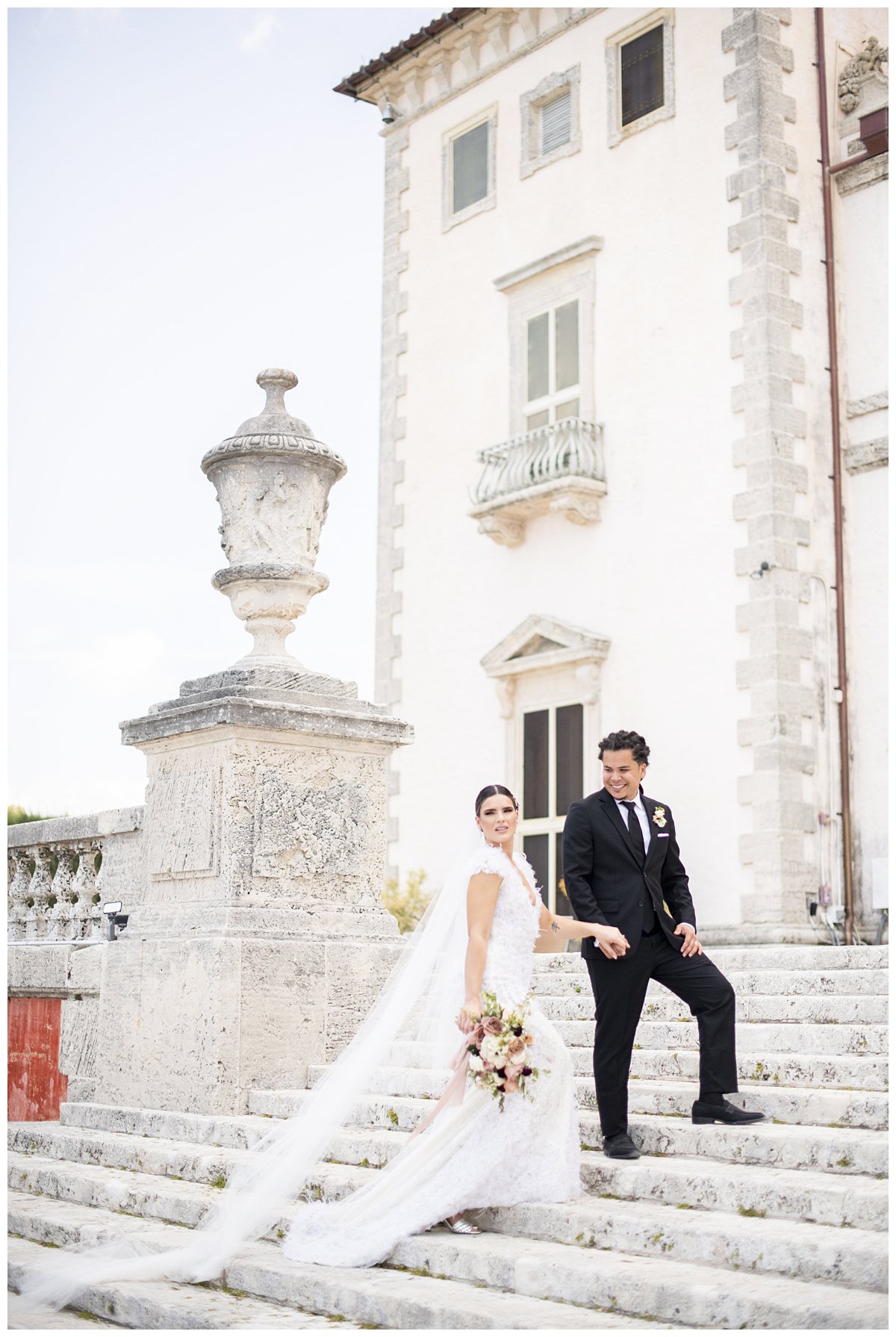 bride and groom walking up the Vizcaya Museum steps for Miami wedding photographer