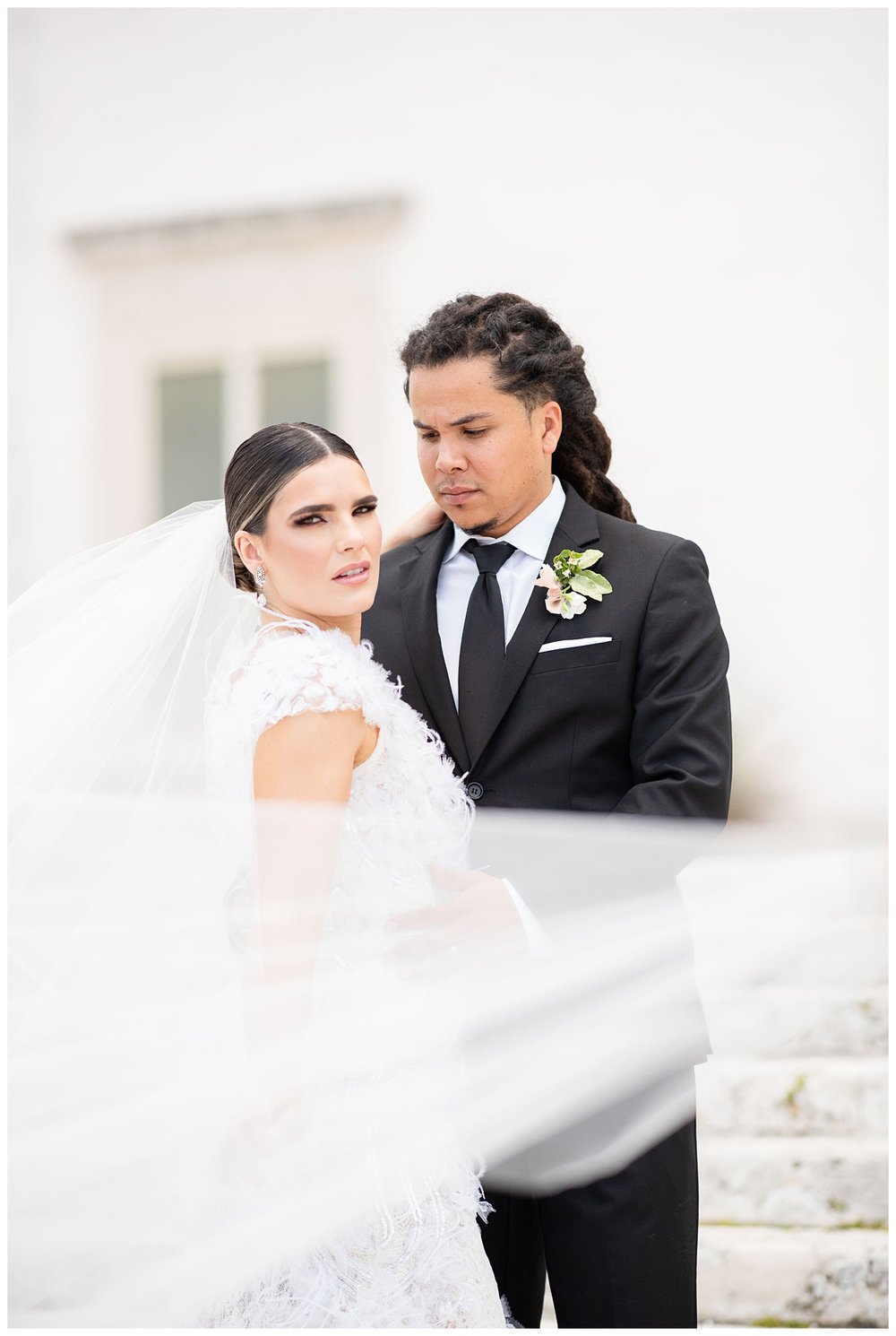 bride and groom with veil flowing at Vizcaya museum