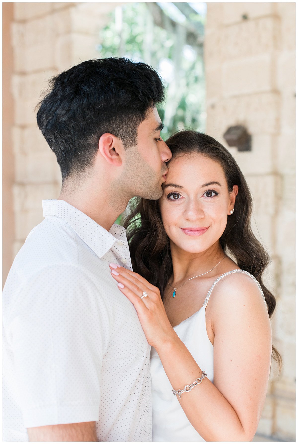 groom kissing his bride during Vizcaya Museum engagement photos