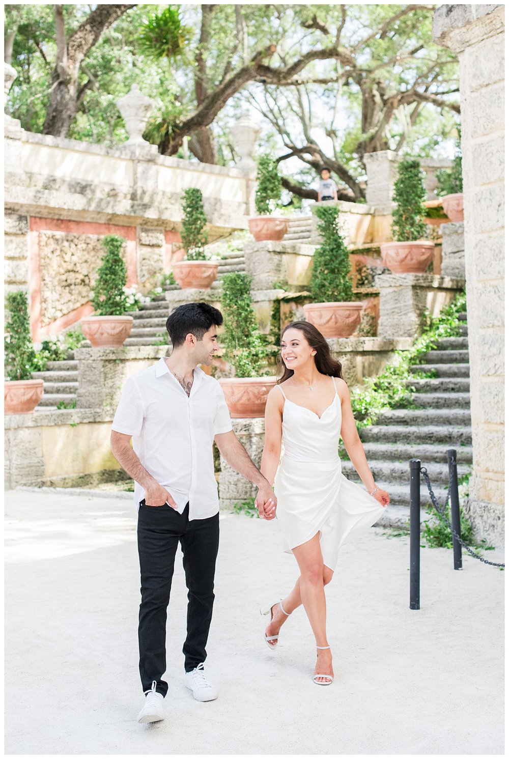 engaged couple in Miami Florida posing in the gardens at Vizcaya Museum