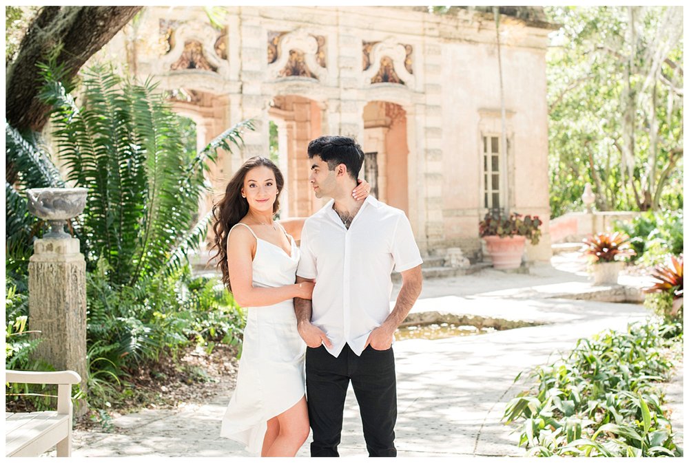 engaged couple standing under a tree for Vizcaya Museum engagement photos
