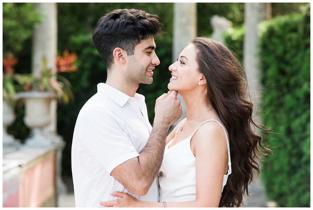 engaged couple staring at each other and smiling for Miami engagement photographer