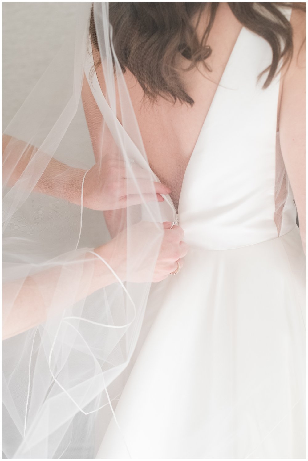 detail image of hands clasping back of white wedding gown Boston wedding photographer