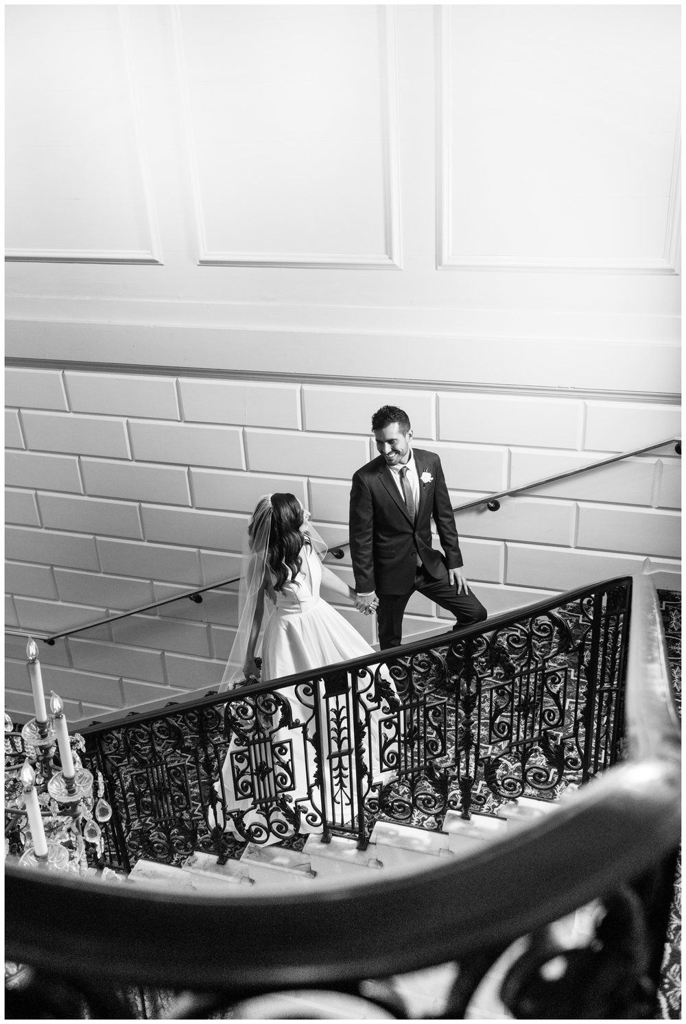 black and white image of newlyweds walking up stairs in The  Hampshire House Boston