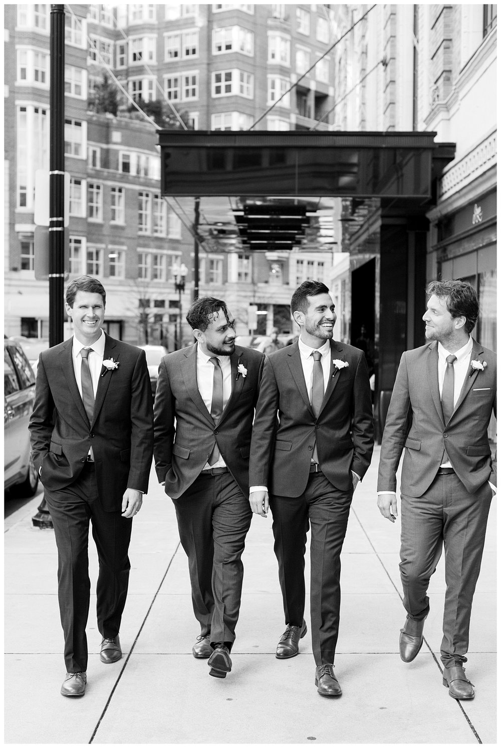 groom walking with groomsmen outdoors Boston street