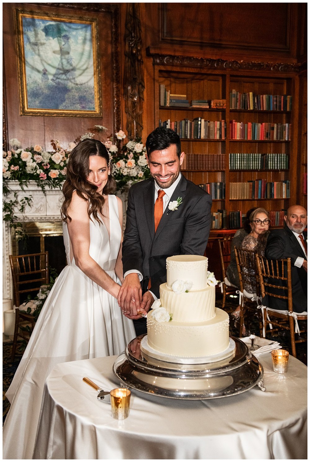 bride and groom cutting cake Boston wedding reception