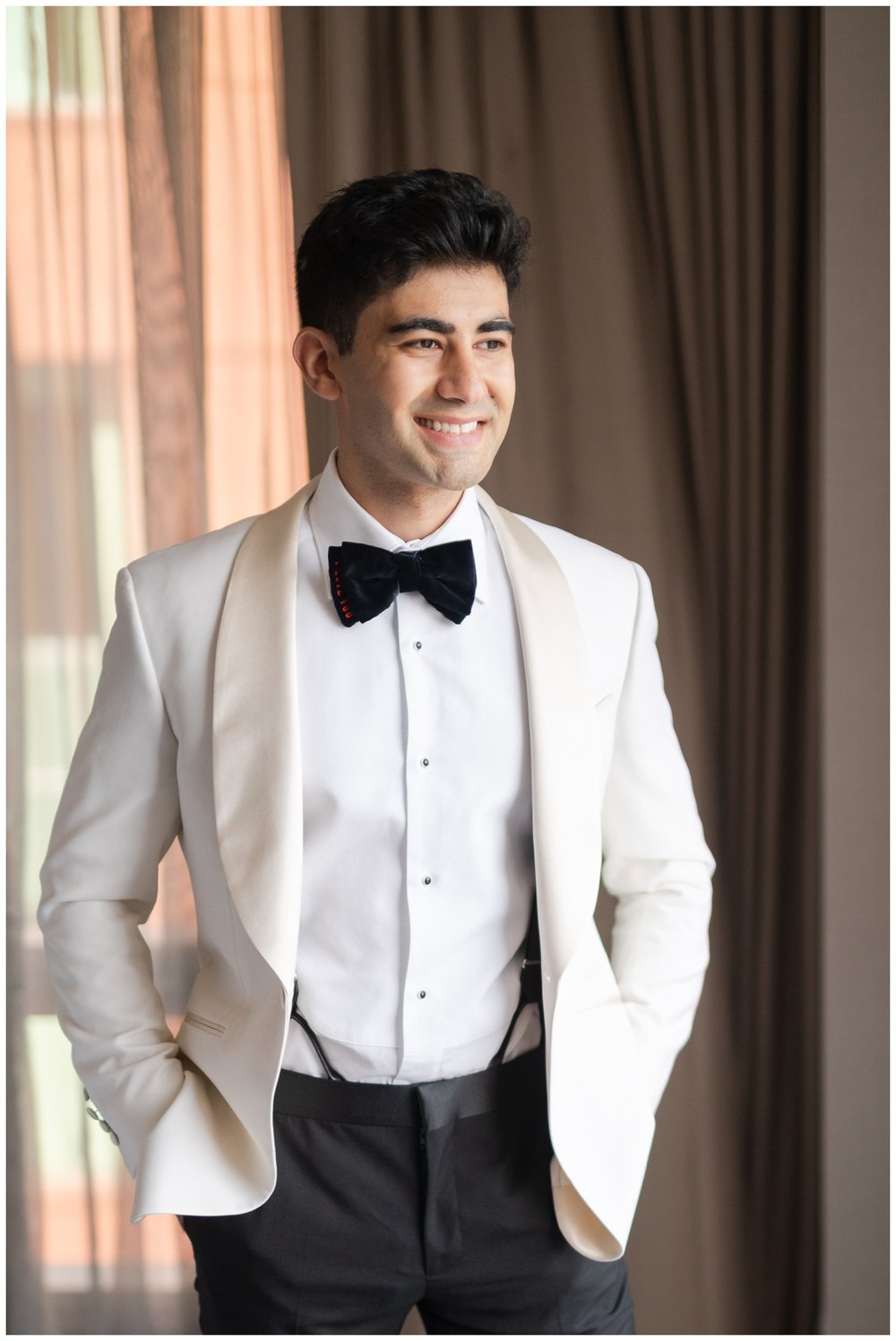 groom smiling at camera in white tux jacket black pants Granite Links wedding