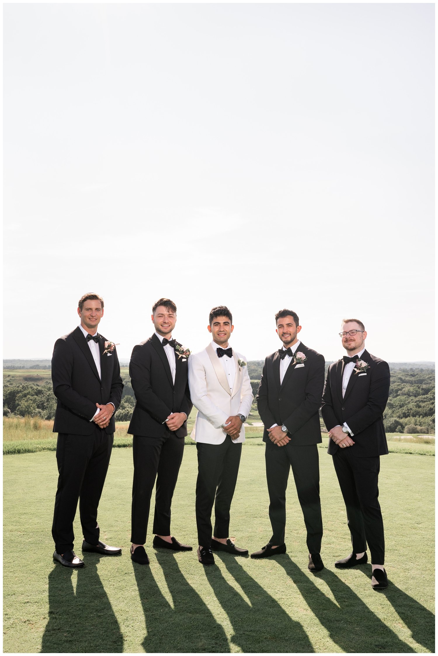 groom and groomsmen standing on Granite Links golf course