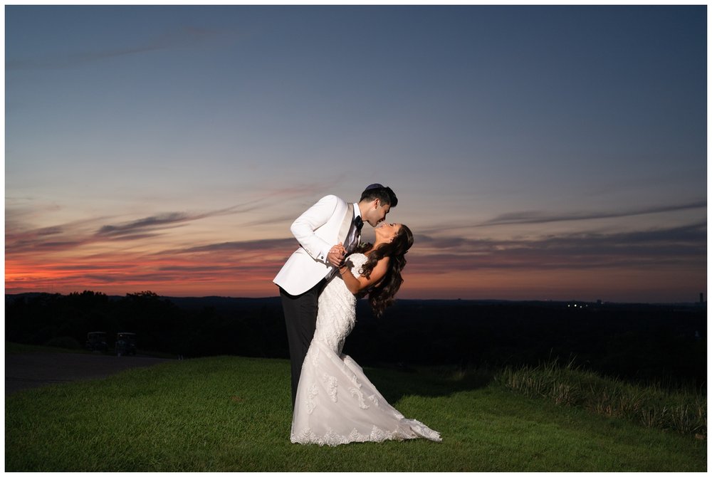 bride and groom kissing night time Granite Links golf course