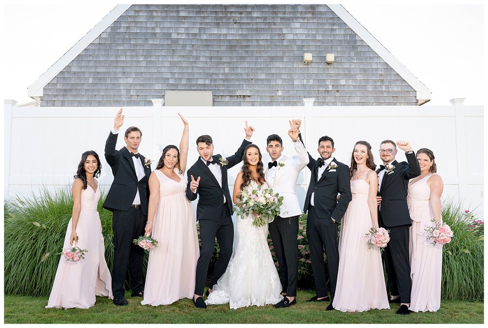 bridal party in black tux and pink dresses celebrating Granite Links golf course