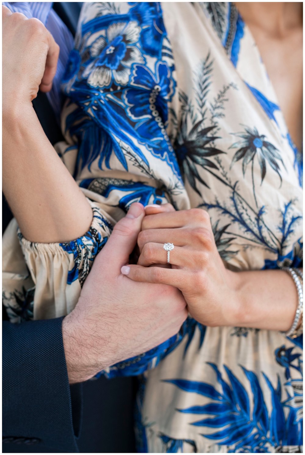 close up image of couple's hands with engagement ring