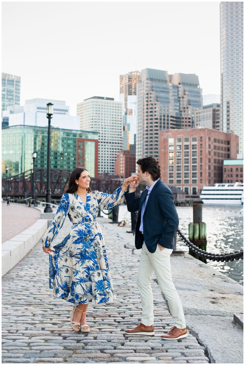 groom kissing brides hand outdoors at Boston Seaport