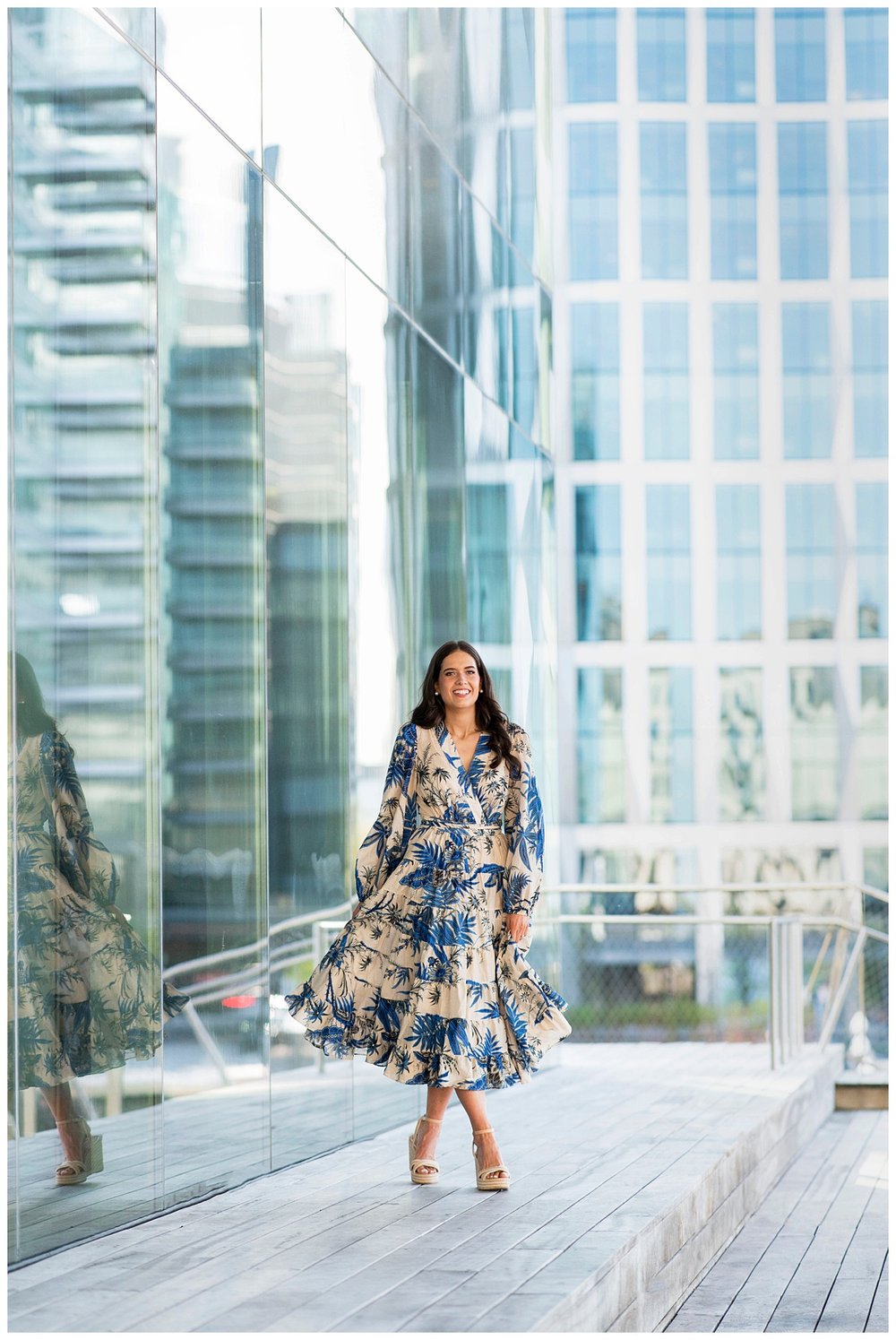 bride in navy and cream floral dress walking and twirling dress