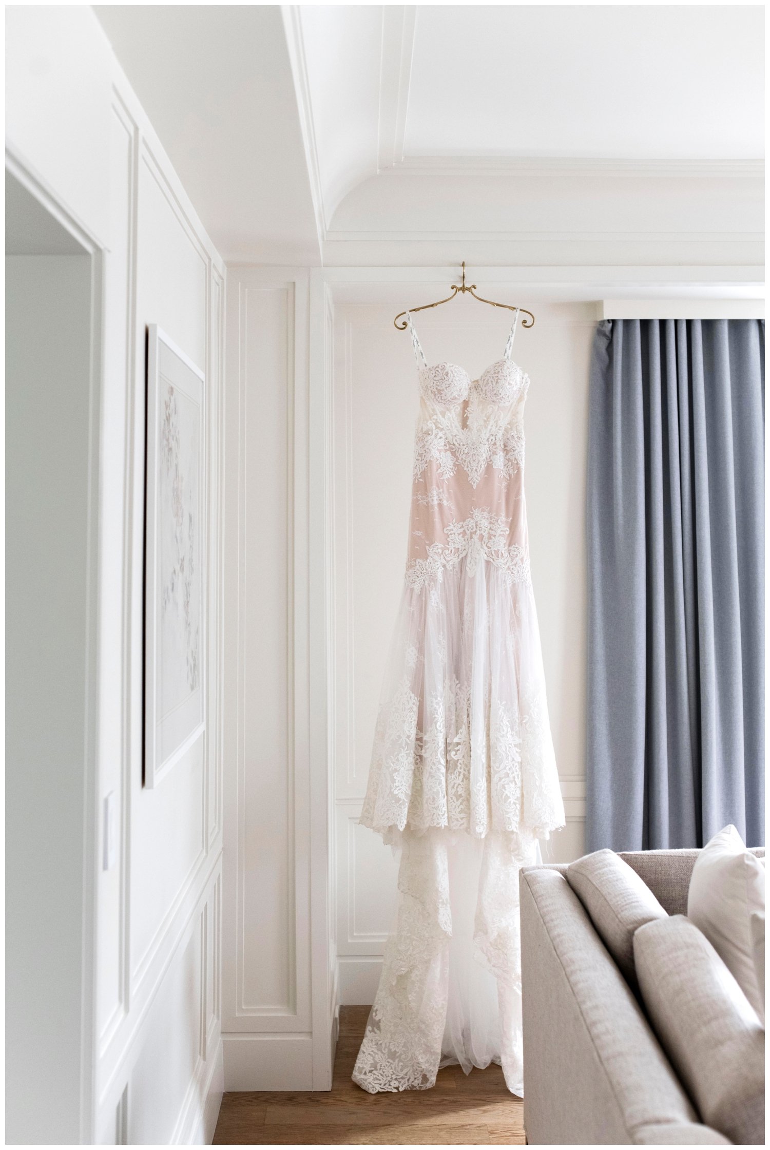 white wedding gown hanging inside a room at The Newbury Hotel in Boston