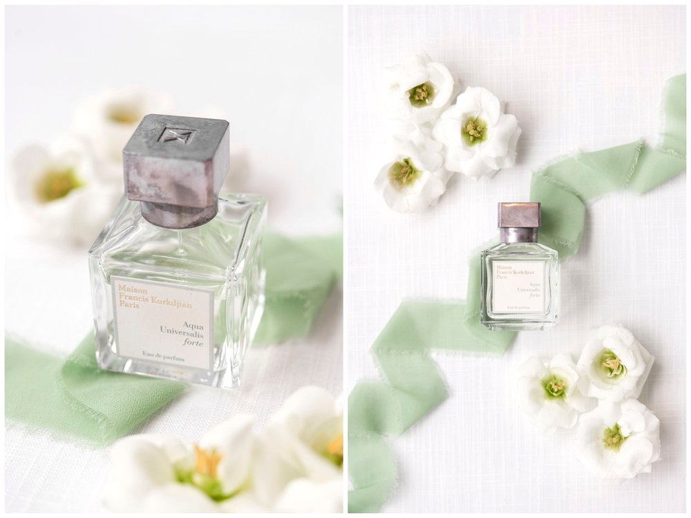 flatlay of white florals and perfume bottle