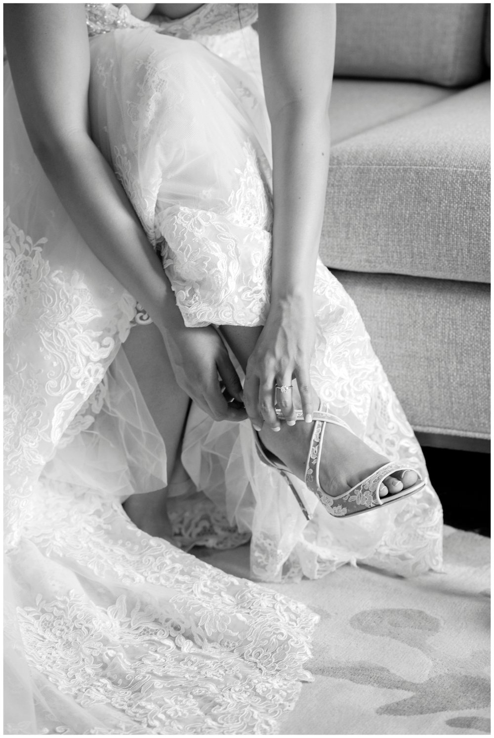 The Newbury Hotel  wedding black and white portrait of bride's hands fastening wedding shoes