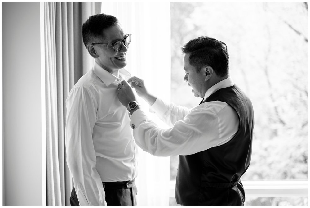 groom getting ready with Dad putting on groom bowtie