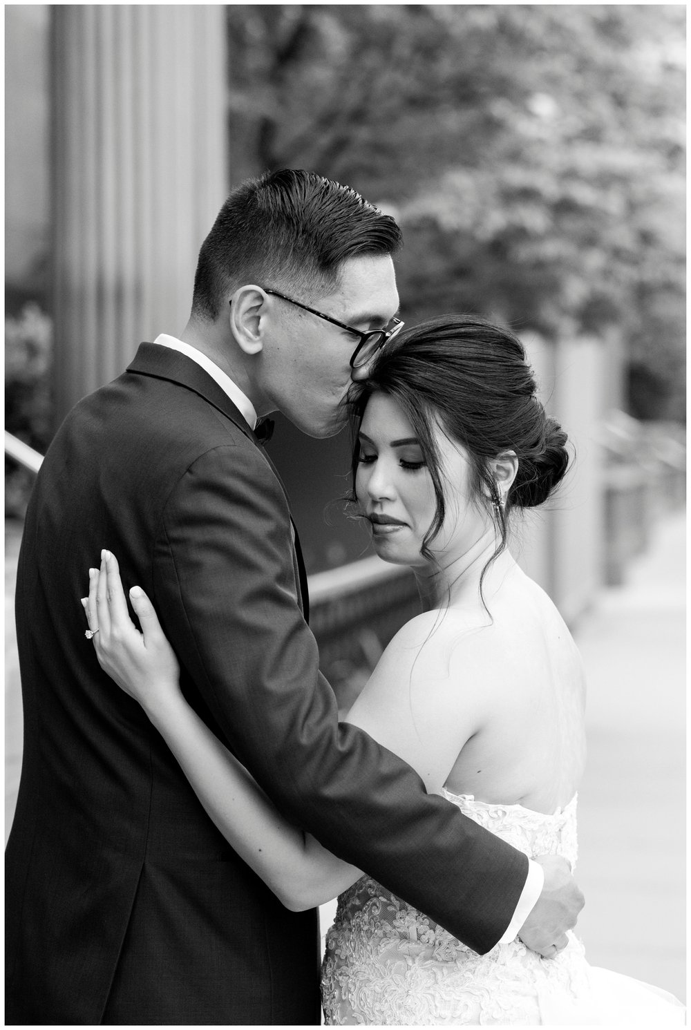 black and white portrait groom kissing top of bride's head
