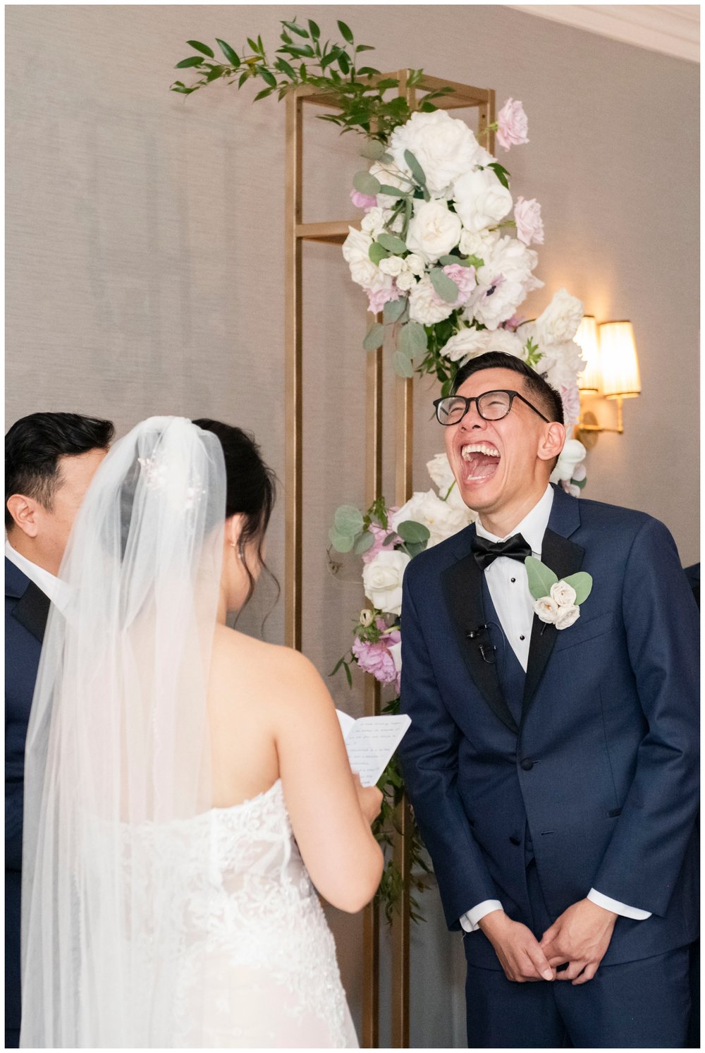 groom laughing during indoor wedding ceremony