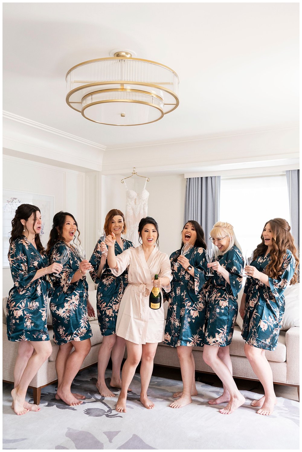 bride and bridesmaids in matching emerald floral robes inside The Newbury Hotel 