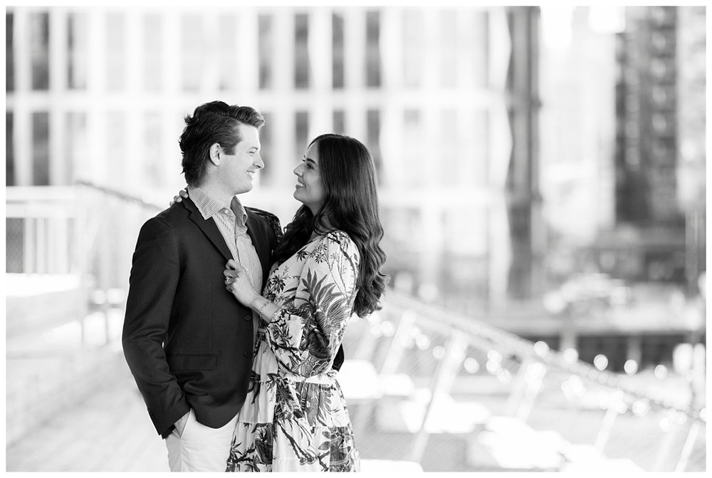 black and white image of couple looking at each other during Boston Seaport engagement session