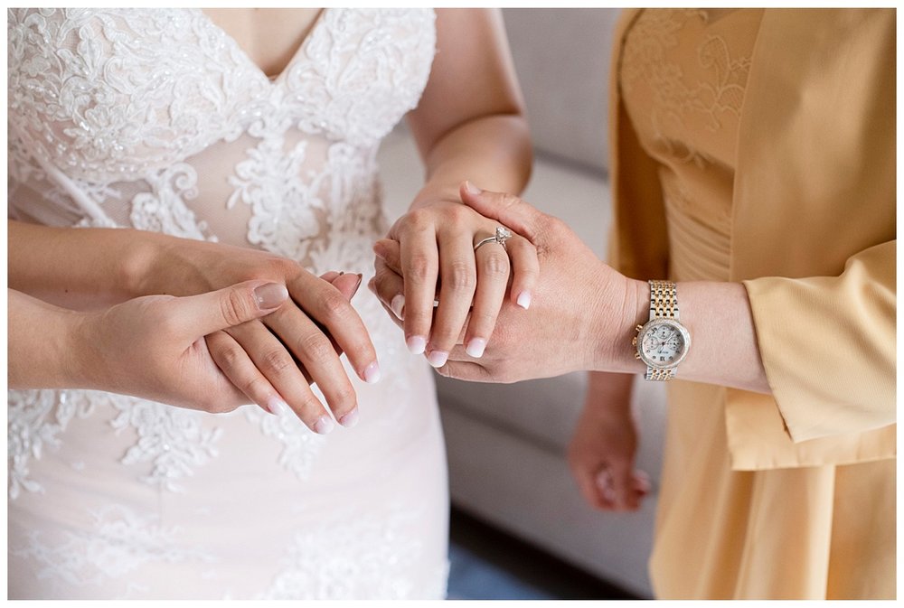 detailed image of hands of bride, mom and maid of honor