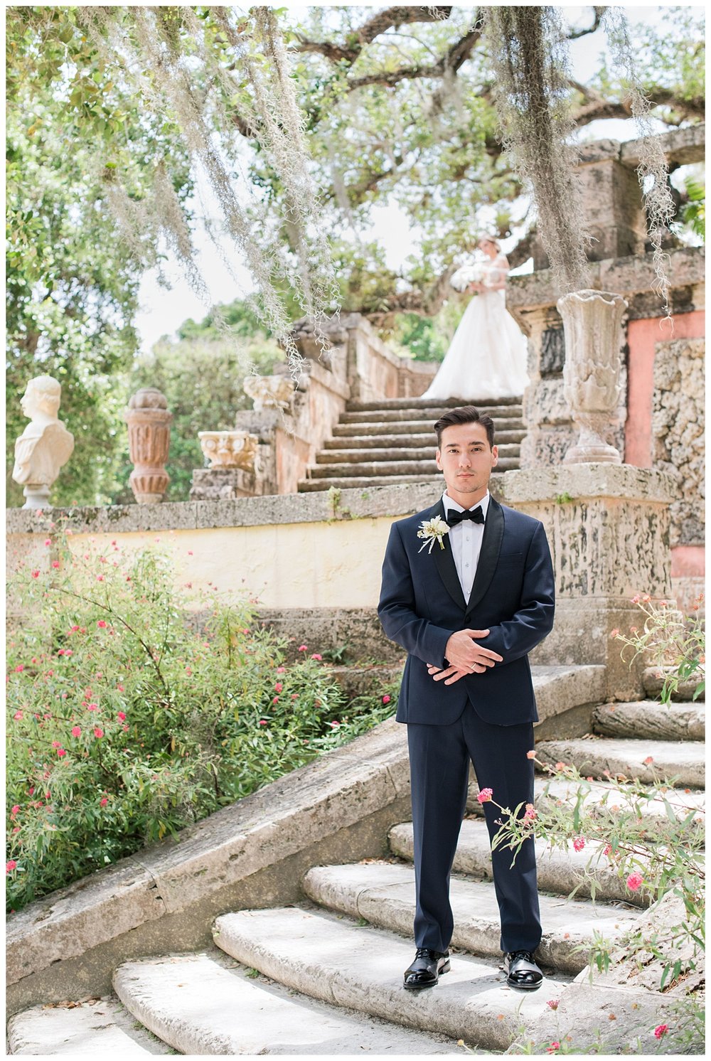 groom standing on steps in black tux at Miami Vizcaya Museum Wedding