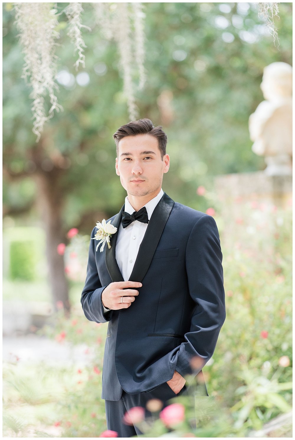 groom standing with hand on black tux jacket outdoors at Miami Vizcaya Museum Wedding