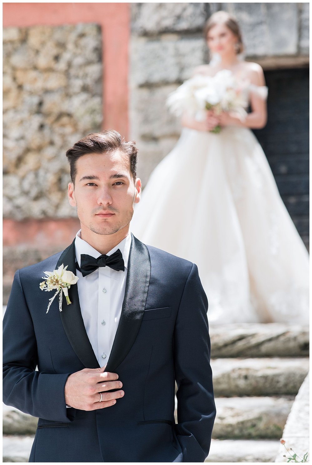 groom in black tux waiting for first look with bride outdoors at Vizcaya Museum and Gardens