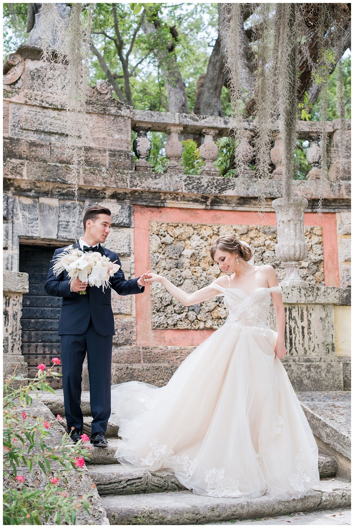 first look with groom holding brides hand outdoors