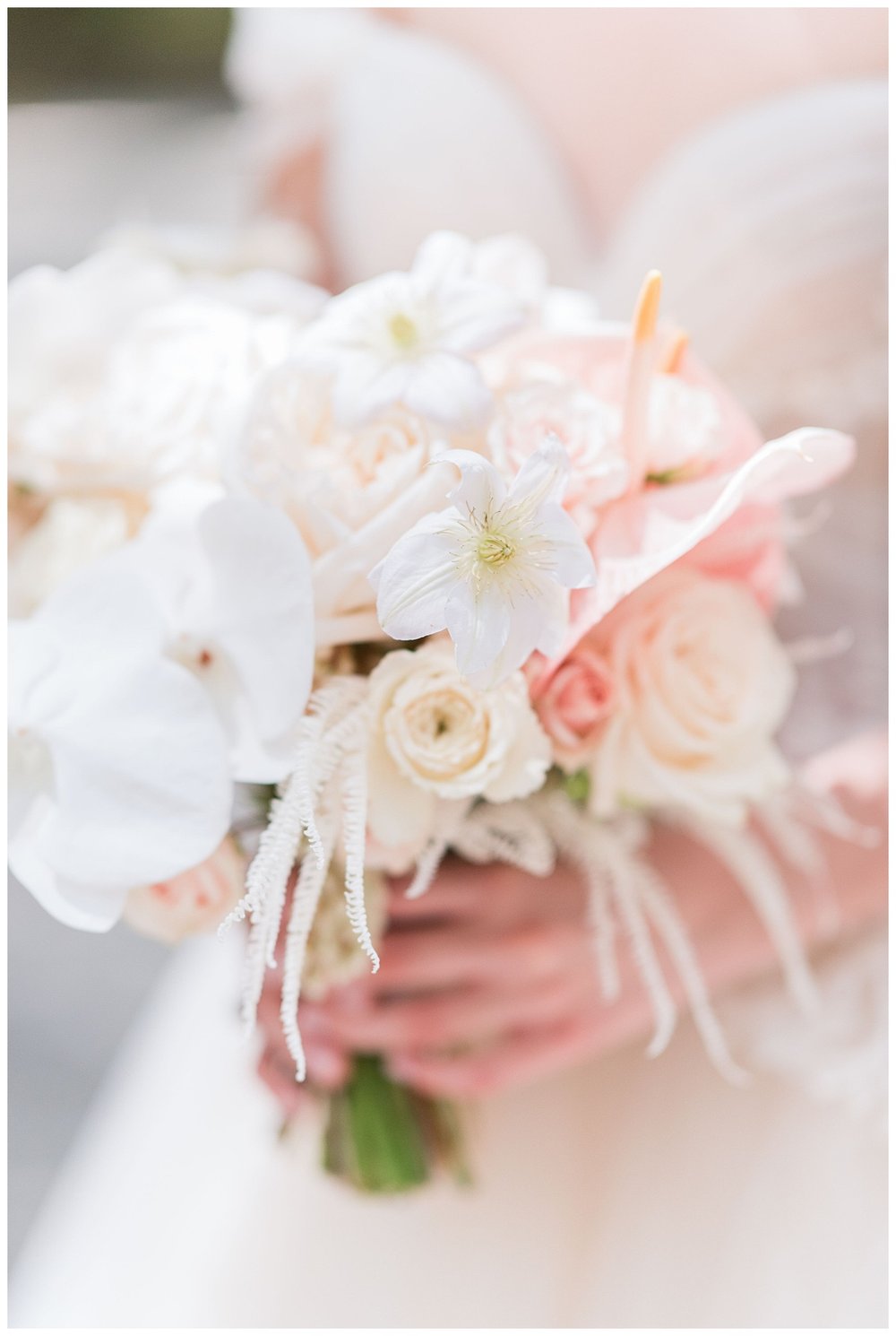 detailed image of white and blush bouquet with brides hands holding it